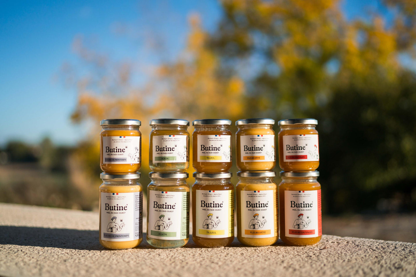 Row of Butine jars with labels on a blurred natural background