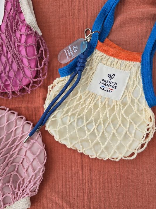 Net bags with visible brand labels on a textured surface