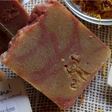 Bar of soap with a cat design on a textured surface